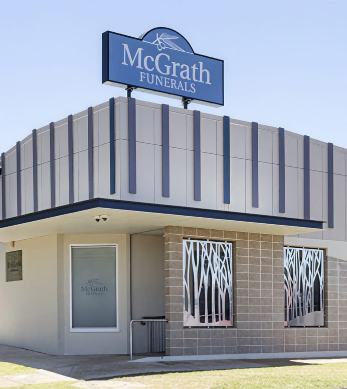 The exterior facade of the McGrath Funerals building with their signage visible from the street